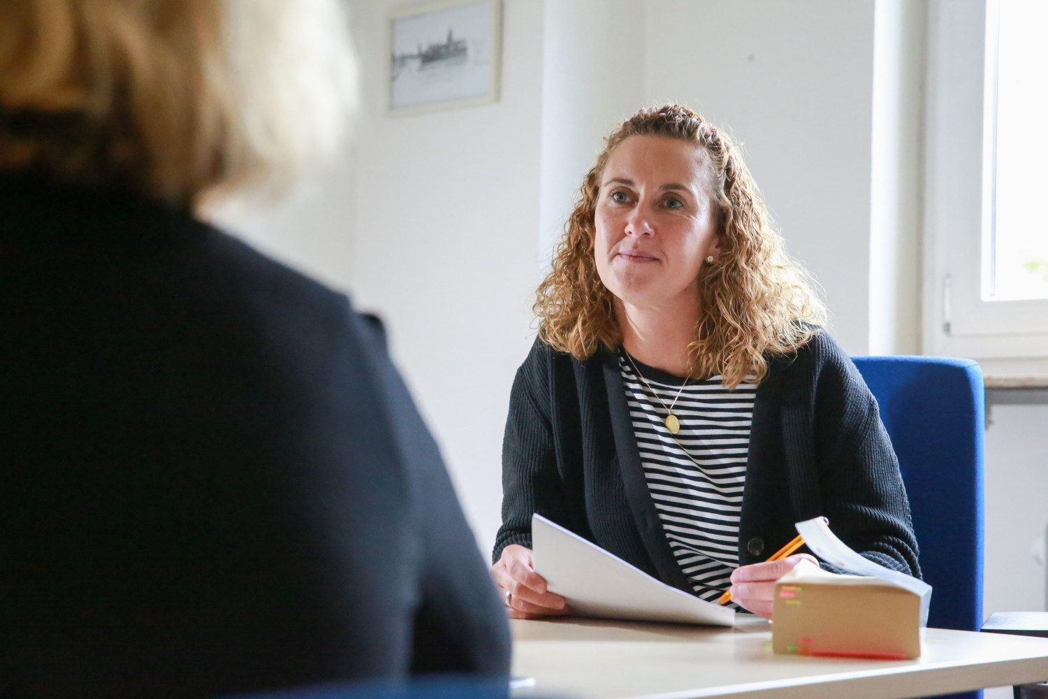 Eine Mitarbeiterin der Stadtmission berät eine Klientin